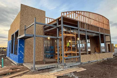 Curved arc framing detail at AFCU Rexburg — vertical wood framing members defining the architectural arc atop the building's second-story volume, integrated with structural steel