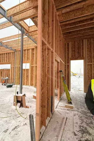 Interior framing at AFCU Rexburg — wood-framed interior walls, steel structural members, and roof framing visible from inside the building shell
