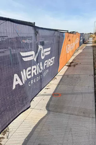 America First Credit Union branded construction fence wrap surrounding the AFCU Rexburg project site