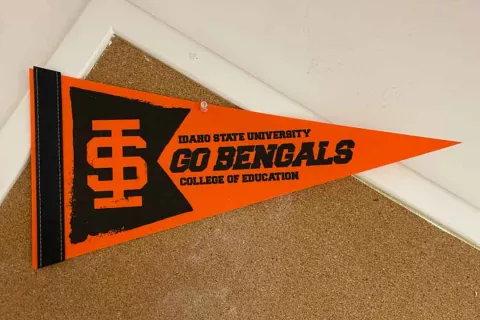Orange "Go Bengals — Idaho State University College of Education" pennant pinned to a corkboard inside Albion Hall