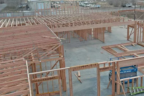 Interior view of wood framing and roof truss system across multiple rooms at IDOC Re-entry Center jobsite