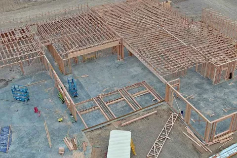 Aerial view of completed roof trusses and wall framing on multiple sections of IDOC Re-entry Center