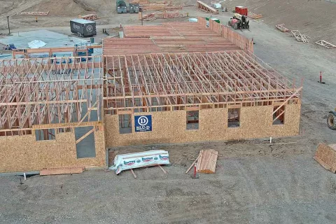 Exterior wall framing with BLU-D Commercial Framers signage on OSB sheathing at IDOC Re-entry Center