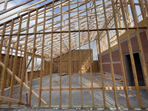 BLU-D framing looking through the framed studs and set trusses to a blue sky at Hibbard Elementary.