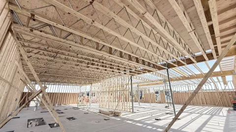 Partial interior timber framing with exposed ceiling joists.