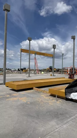 Single Glulam beam set on supportive structural metal posts.