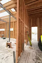 Interior framing at AFCU Rexburg — wood-framed interior walls, steel structural members, and roof framing visible from inside the building shell