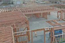 Interior view of wood framing and roof truss system across multiple rooms at IDOC Re-entry Center jobsite