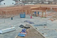 Wide interior view of framed walls and roof trusses across the IDOC Re-entry Center construction site