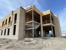 BLU-D Framing exterior view with blue sky of the stairwell meeting up with the masonry exterior wall at Alpine Academy
