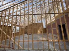 BLU-D framing looking through the framed studs and set trusses to a blue sky at Hibbard Elementary.