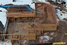 BLU-D Framing aerial view of partially set trusses on hip roof line of Pocatello Children's Clinic