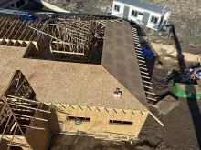 BLU-D Framing aerial view of partially sheathed hip roof on Pocatello Children's Clinic