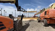 Telehandler with jib and manlift installing beams.