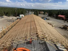 Roof trusses set along the length of the Island Park Adventure Lodge, seen from above