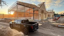 Island Park Adventure Lodge framing at sunset, a BLU-D pickup in front