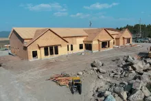 Aerial view of the Island Park Adventure Lodge, its gabled wings framed and sheathed