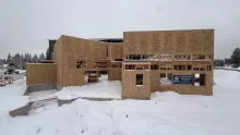 Playmill Theater's framed front buildings, sheathed in OSB, in deep snow