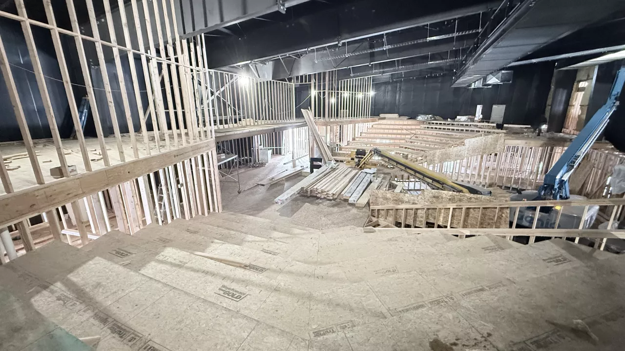 Stepped seating platforms framed in wood inside the Playmill Theater auditorium