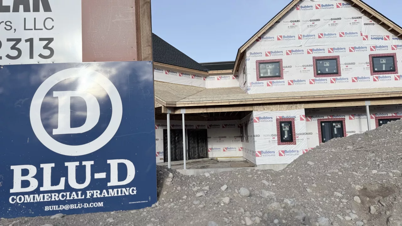 BLU-D Commercial Framing sign in front of the Playmill Theater, its walls wrapped and windows in
