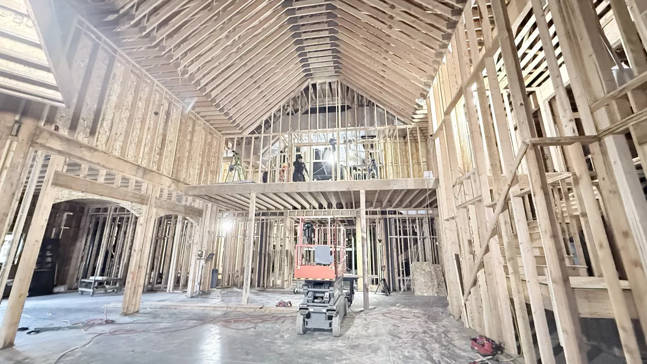 Tall wood-framed hall inside the Playmill Theater, a framed loft under the vaulted roof