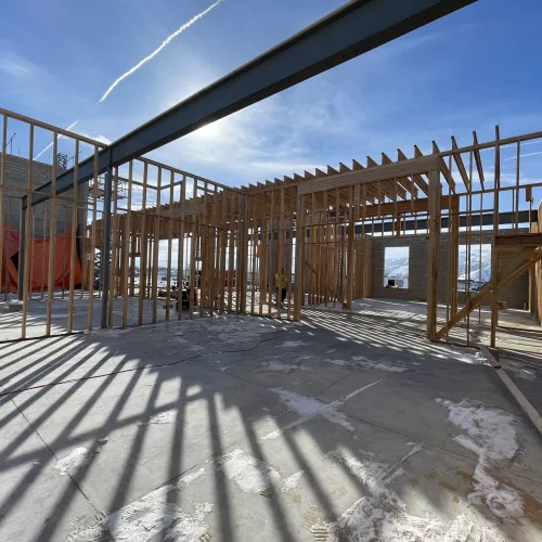 BLU-D Framing steel beam with partially framed in rooms and blue sky.